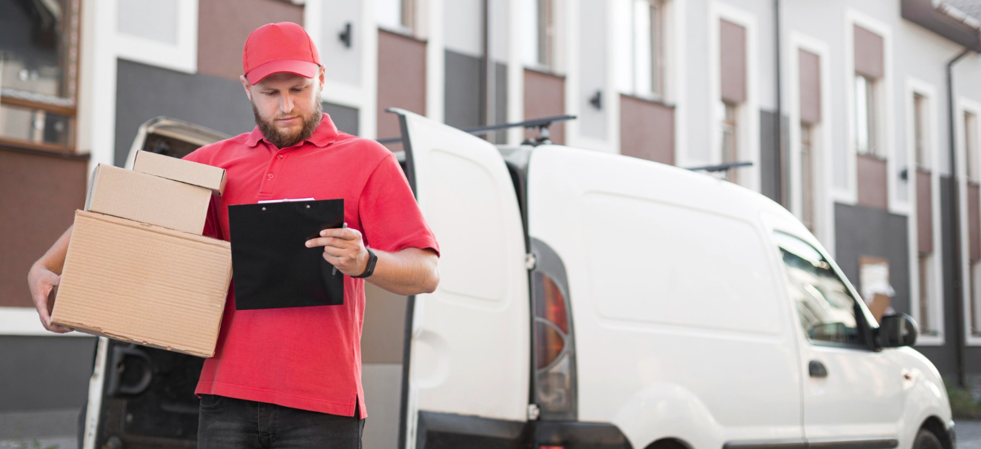 delivery driver standing next to a white van with top of the range van security systems